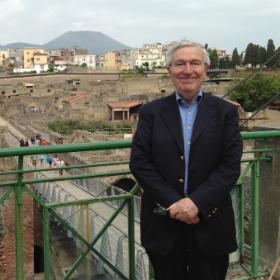 Professor Stephen Bann standing in front of the ruins at Herculaneum.
